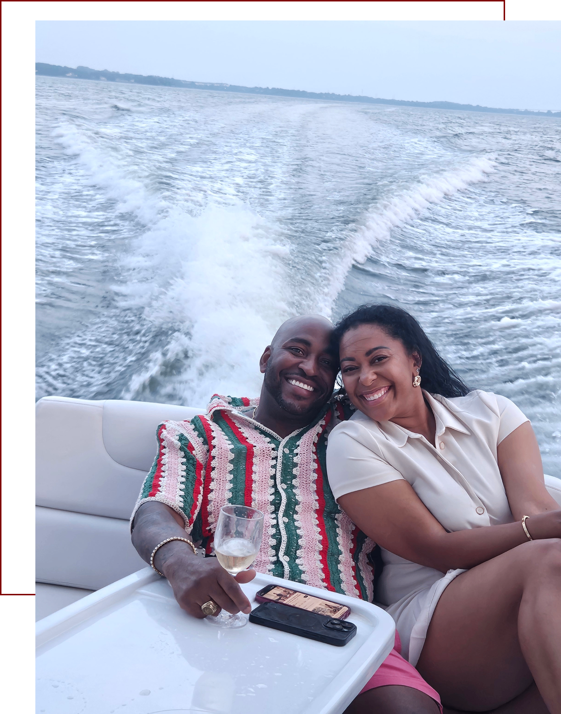 A happy couple enjoying a boat ride on a sunny day.
