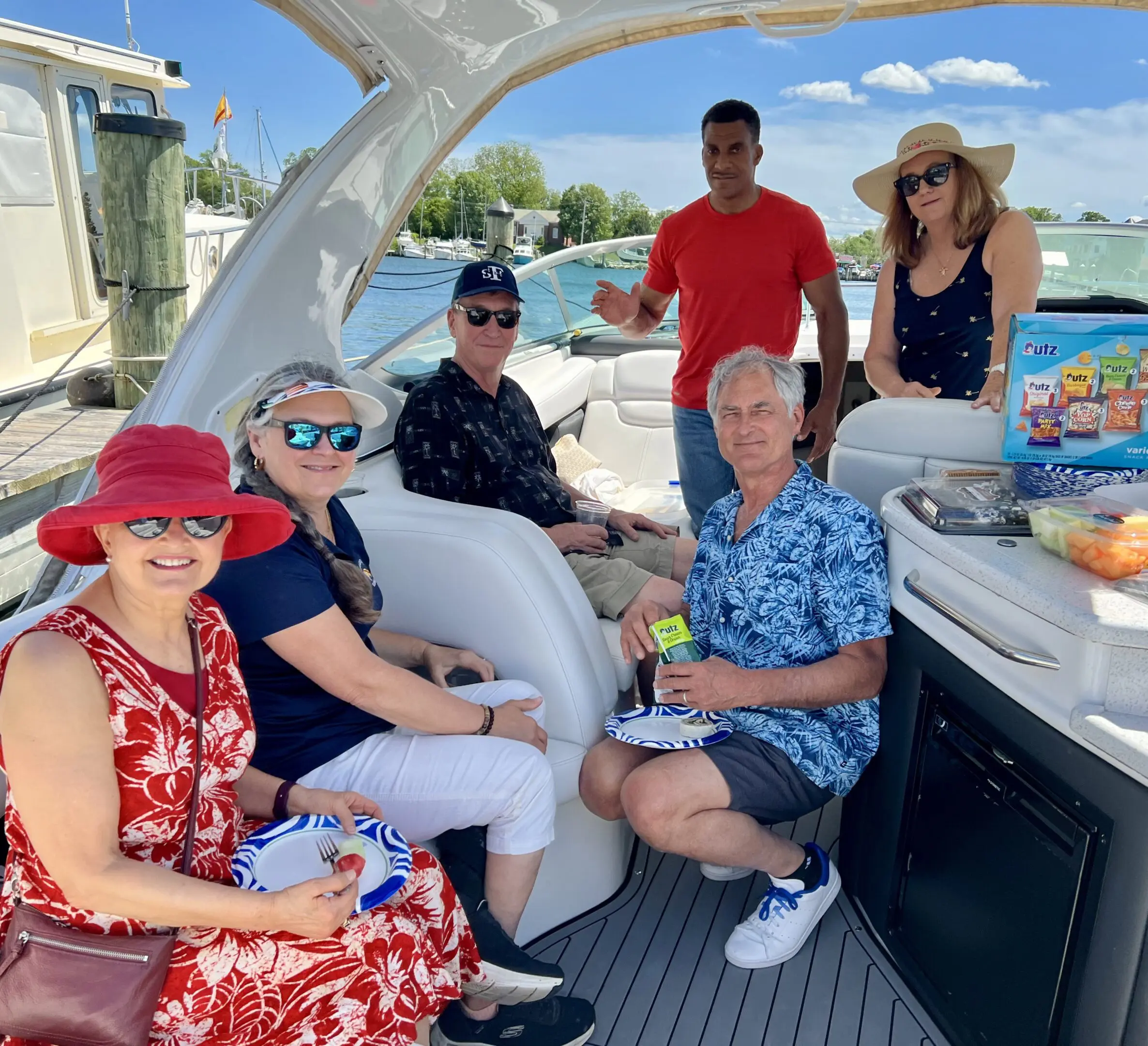 A group of six people enjoying a sunny day on a boat.